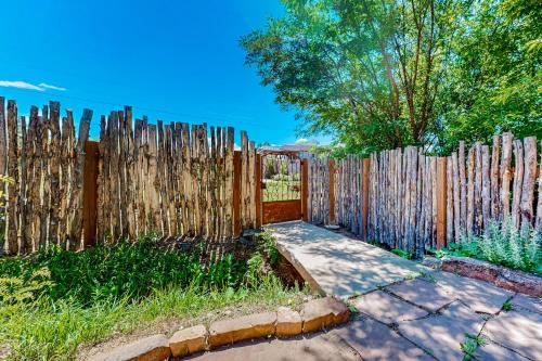 a wooden fence in a yard with a sidewalk at Casa del Sueños in Taos