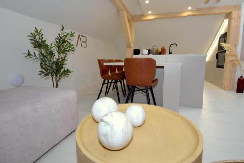a living room with a table with white balls on it at Apartamenty Blanca in Łeba