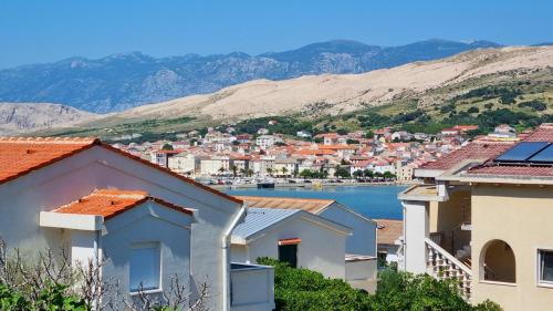 a view of a town with mountains in the background at Apartments Šešo in Pag