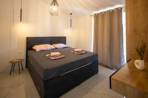a bedroom with a bed with two towels on it at Apartmani Ante & Ivano Biograd with POOL in Biograd na Moru
