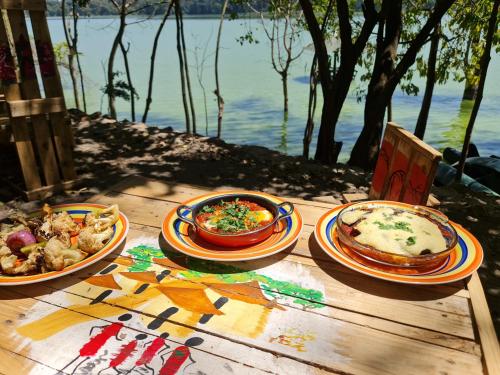 a wooden table with plates of food on it at Holiday cottage by the river, Arusha in Arusha