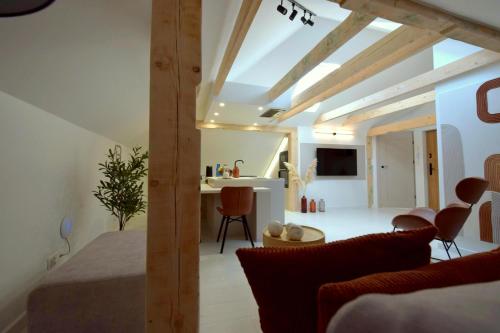 a bedroom with a bed and a living room at Apartamenty Blanca in Łeba