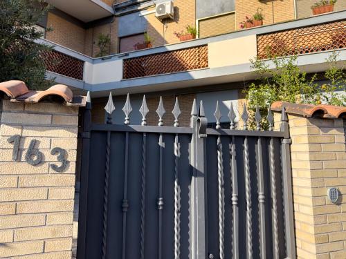 a black fence on the side of a building at ISOLA 163 Guest House in Fiumicino