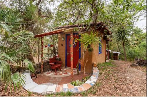 a small house in the middle of a forest at Casa Ecológica in Tepoztlán