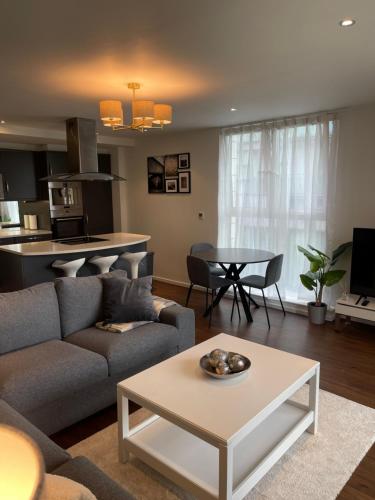 a living room with a couch and a table at Modern Luxury 2 bedroom apartment in London Excel in London