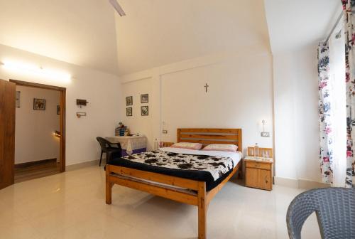 a bedroom with a bed and a table and a chair at Dale Villa in Borpāni