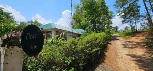 a sign in front of a house on a dirt road at Dale Villa in Borpāni