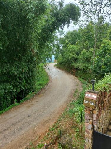 a dirt road with a sign on the side of it at Dale Villa in Borpāni