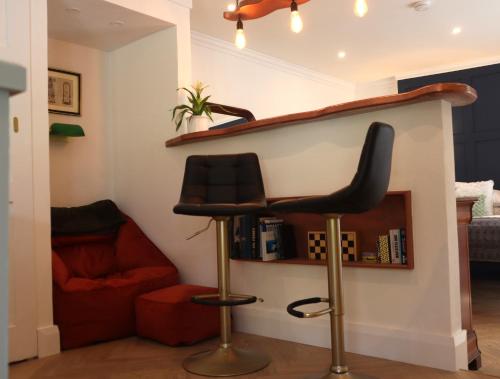 a bar stool in the corner of a living room at The Garden retreat in Killarney