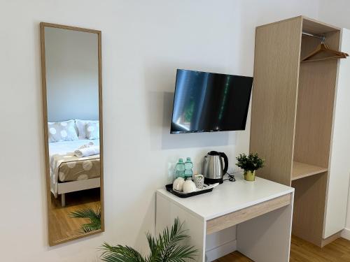 a mirror on a wall in a room with a bed at ISOLA 163 Guest House in Fiumicino