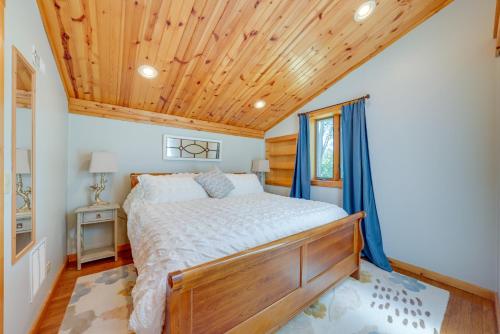 a bedroom with a bed and a wooden ceiling at Peaceful Warrenville Home 1 Mi to Herrick Lake! in Warrenville
