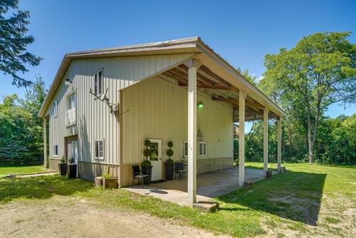 a large white barn with a porch at Peaceful Warrenville Home 1 Mi to Herrick Lake! in Warrenville