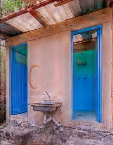 a bathroom with a sink and a blue door at Casa Ecológica in Tepoztlán