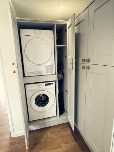 a kitchen with a washer and dryer in a closet at Living Like a Local at Dotties in Outwell