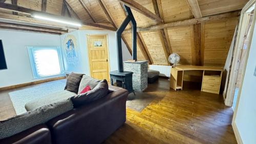 a living room with a couch and a stove at Hisa Luciano For 5 Near Bovec in Bovec