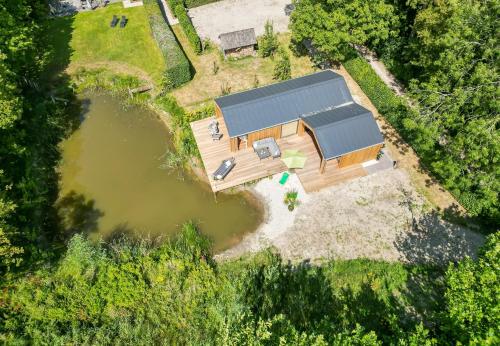 an overhead view of a house with a pond at NEW Hello Zeeland - Watervliet Oyster Lodge in Wissenkerke