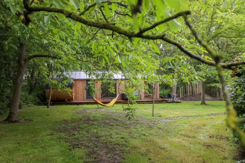 a hammock in the middle of a yard at NEW Hello Zeeland - Watervliet View Lodge in Wissenkerke