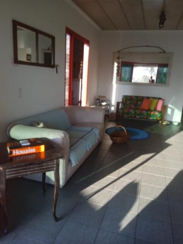 a living room with a couch and a table at Suíte casal 5min a pé da praia da Enseada in Guarujá