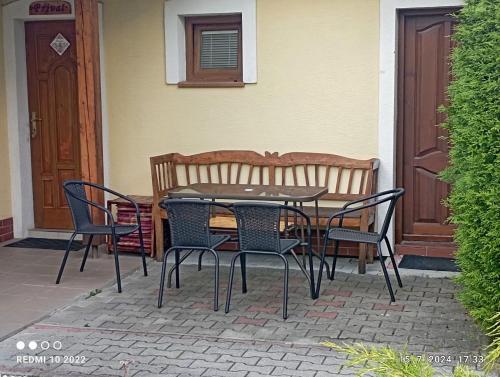 a patio with a table and chairs in front of a house at Apartmán " Matej" in Smrečany