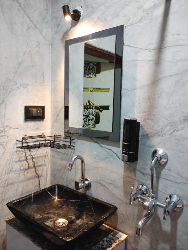 a bathroom with a black sink and a mirror at Lepcha Homestay Darjeeling in Darjeeling