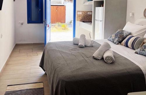 a bedroom with a large bed with towels on it at Kimolos Seafront in Kimolos