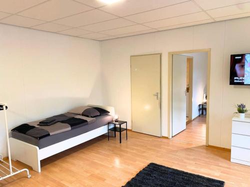 a bedroom with a bed and a flat screen tv at For Workers Bedburg Hau in Bedburg Hau