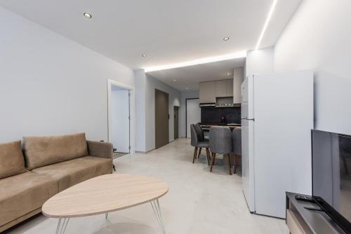 a living room with a couch and a table at SR Apartments Golem in Golem