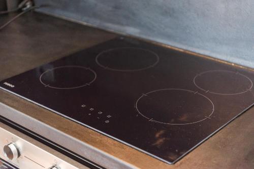 a stove top with a bunch of circles on it at SR Apartments Golem in Golem