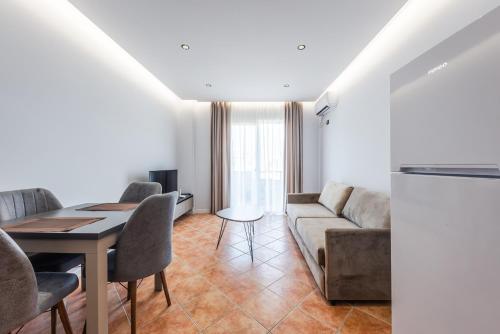 a living room with a couch and a table at SR Apartments Golem in Golem