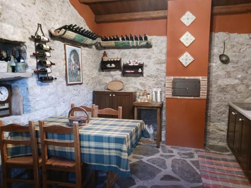 a dining room with a table and a wine cellar at Casa vacanze San Giorgio in Alcara li Fusi