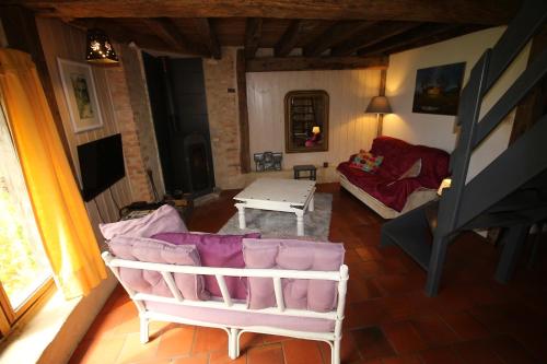 a living room with a couch and a table at Le chant du coucou in Bois Gars