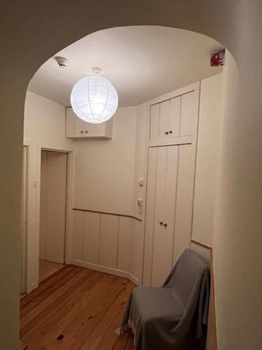 an empty room with a hallway with a large light at Hideaway Garden Paradise in Dublin