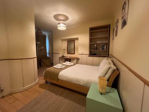 a bedroom with a bed and a table in it at Hideaway Garden Paradise in Dublin