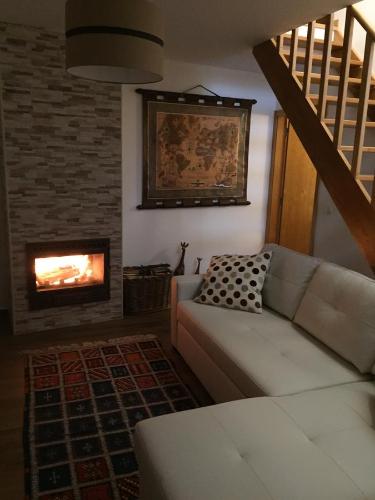 a living room with a couch and a fireplace at Moinhos do Pisão in Povoa Dao