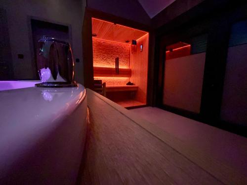 a dark room with a room with a bed and a window at Pause Thermale Suites Deluxe et Spa Privatif in Herstal