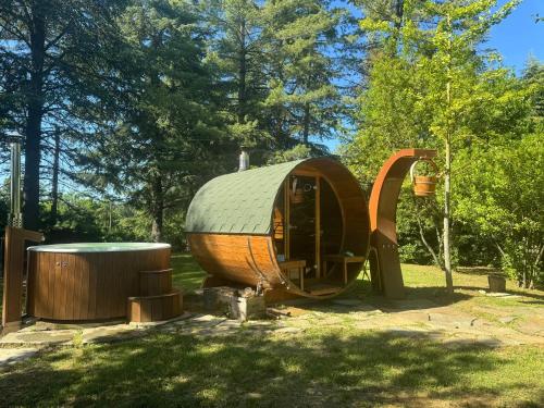 a circular wooden hobbit house in a park at Cozy Chalet in Castell'Arquato 90 m² with Private Pool in CastellʼArquato