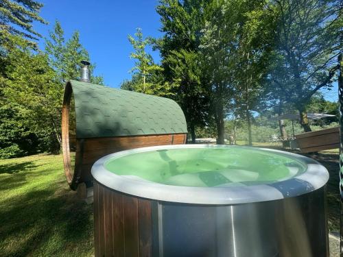 a hot tub in a yard next to a house at Cozy Chalet in Castell'Arquato 90 m² with Private Pool in CastellʼArquato