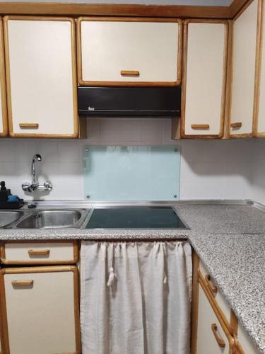 a kitchen with a sink and a counter top at Casa Perulo in Mombeltrán