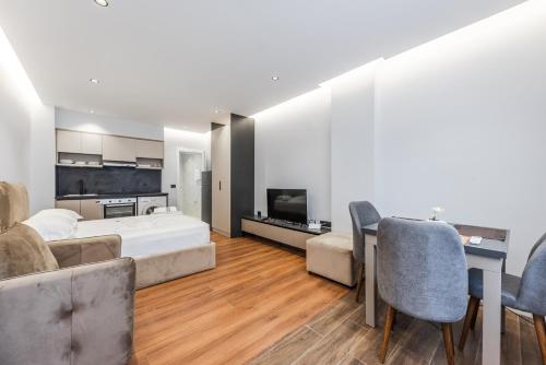 a bedroom with a bed and a table and chairs at SR Apartments Golem in Golem