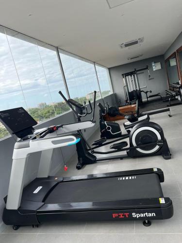 a room with a gym with a treadmill and a laptop at Urban by CityBlue Hotel, Dar es Salaam in Dar es Salaam