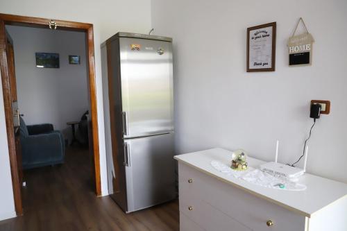 a kitchen with a refrigerator in a room at Villa Fjorentin Berat in Berat