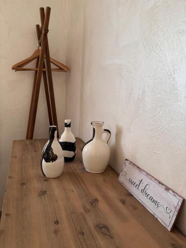 a group of vases sitting on a wooden table at Amor, flat with private hot tub, breathtaking views and free parking in a garage, bookable all year round, Also take a look at our flat Coccolina in Rabac