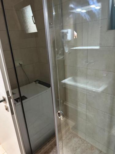 a shower with a glass door in a bathroom at Cindy Luxury Villas Crete GR in Stavros