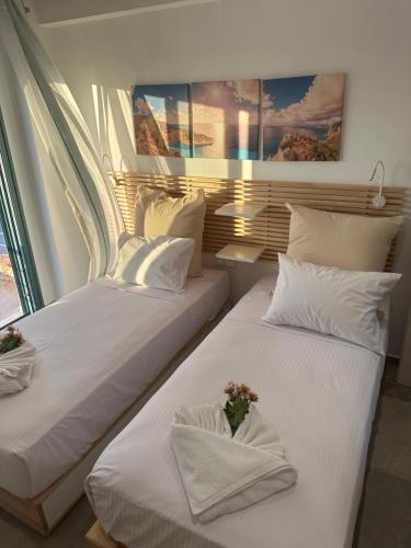two beds sitting next to each other in a room at Cindy Luxury Villas Crete GR in Stavros