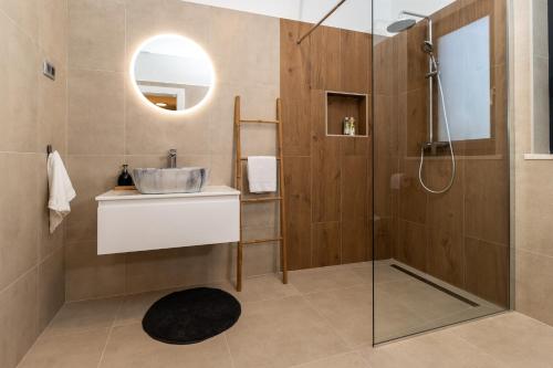 a bathroom with a sink and a shower at Villa Photinia in Labin