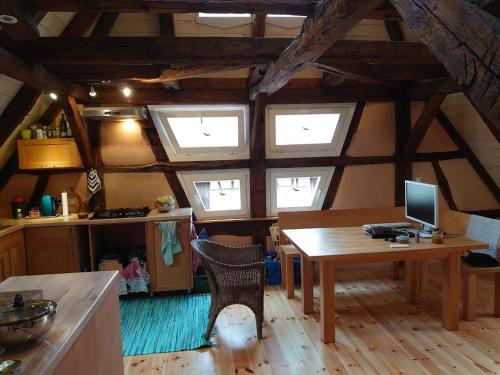 a kitchen with a table with a computer on it at Gemütliche Gästezimmer in einem neu sanierten Fachwerkhaus in Sachsenheim