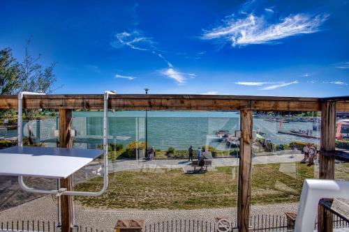 a deck with a view of the water at Willa Z Widokiem na Jezioro in Ryn