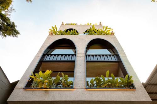 a building with two windows with plants in them at Primavera Luxury Apartments Medellin in Medellín