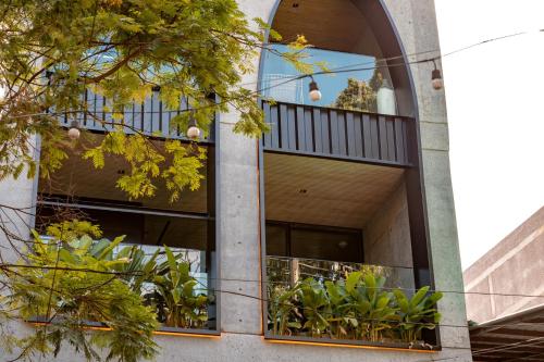 a building with a balcony with plants in it at Primavera Luxury Apartments Medellin in Medellín