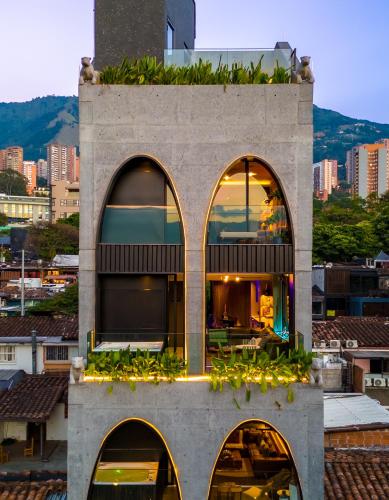 a building with three arched windows on top of a building at Primavera Luxury Apartments Medellin in Medellín